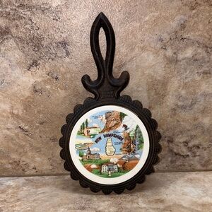 vintage cast iron trivet featuring a ceramic tile insert New Hampshire 7”- 7/8”